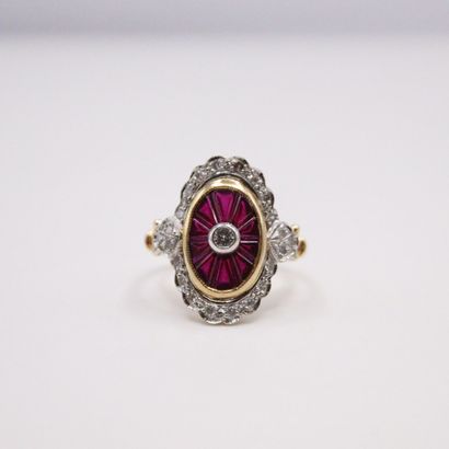 null 18k (750) yellow and white gold ring set with a diamond and calibrated rubies...