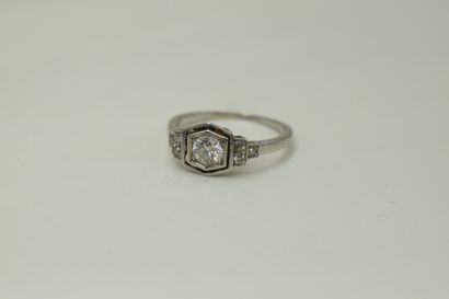 null Platinum ring set with a round old cut diamond supported by three smaller
three...