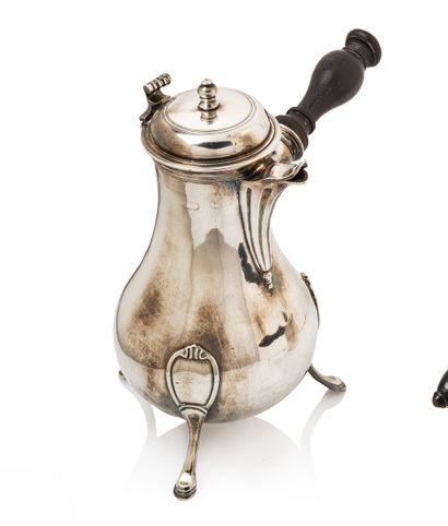 null Silver tripod coffee pot, of baluster form. The fluted spout, the balustered...