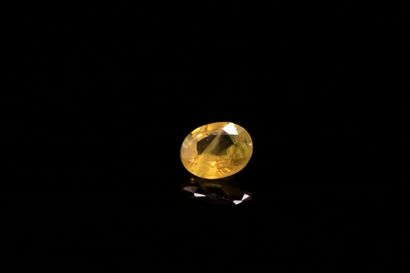 Oval yellow sapphire on paper.
Slight color...