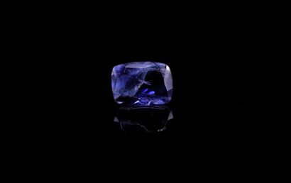 Iolite cushion on paper. 
Weight : 1.31 ct....