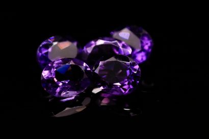 Mixture of five oval amethysts on paper....