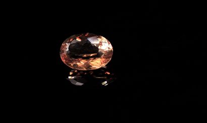 null Oval peach-champagne topaz on paper. 
Weight: 5.32 cts. 

Dimensions: 12mm x...