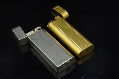 null CARTIER
Two lighters, one in silver-plated metal, the other in gold-plated metal....