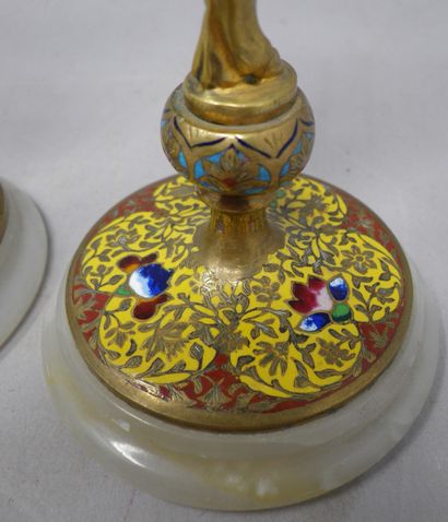 null Pair of small bronze and cloisonné enamel candlesticks featuring a putti with...