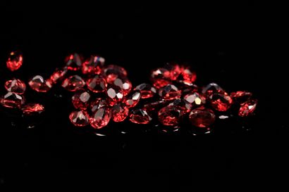 Mixture of thirty-five oval red garnets on...