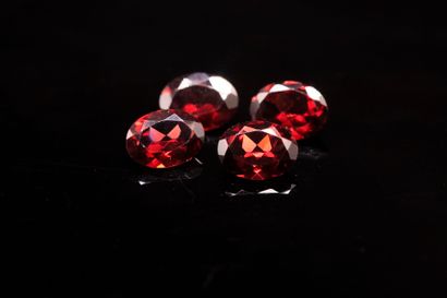 Mix of four oval red garnets on paper.
Weight...