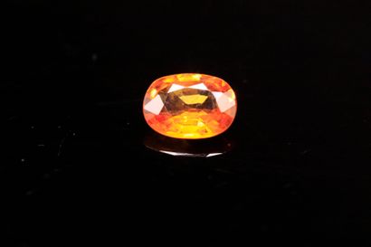 Oval yellow-orange sapphire on paper.
Weight:...