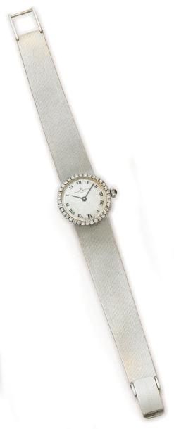 BAUME ET MERCIER Montre bracelet, de dame, ronde (diamètre 21mm) en or blanc 18K...