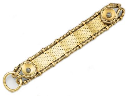 null Large bracelet souple en or jaune articulé, bordé d'une chaîne serpent et présentant...