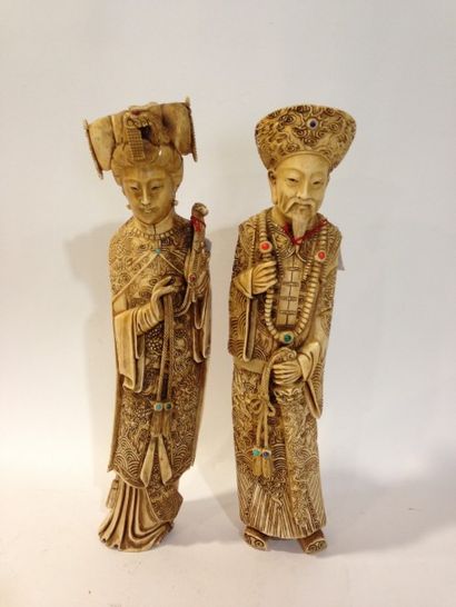null Deux okimono 

figurant un couple de dignitaires en ivoire avec des incrusrtations...