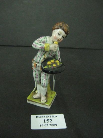 null Statuette représentant un enfant au chapeau contenant des fruits, en porcelaine....