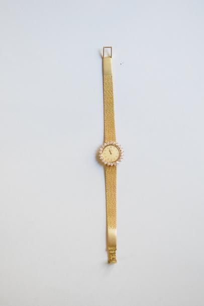 null OMEGA 

Montre bracelet de femme en or jaune 18k (750), boitier rond orné de...