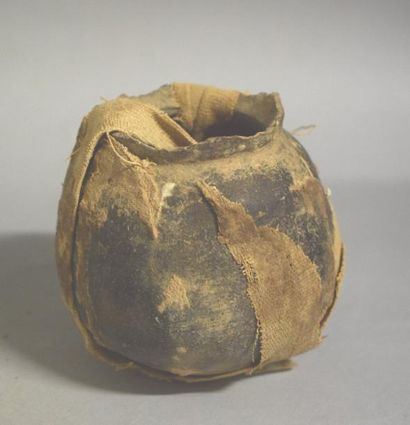 null Vase rituel en terre cuite de forme globulaire entouré de bandelettes de lin.

Egypte,...