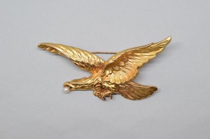 null Broche or jaune 18k (750) stylisée d'un aigle ciselé au naturel tenant dans...