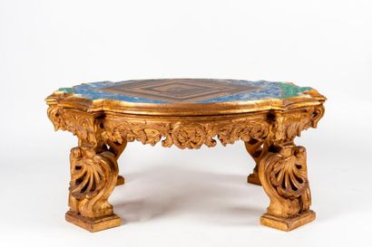 null Table basse en bois sculpté et doré reposant sur quatre pieds formés de coquille...