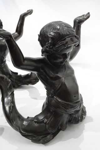 null Bronze and glass Putti di Mare coffee table, with a decor of two bronze cherubs...