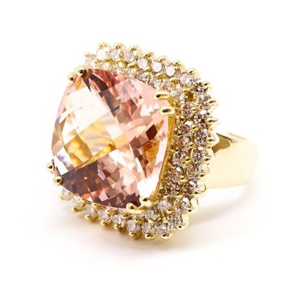 null A 14K yellow gold ring, featuring a cushion-cut morganite within a double border...