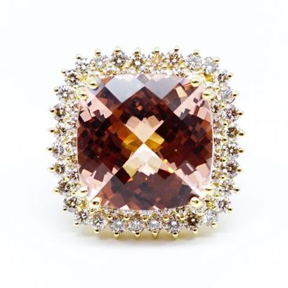 null A 14K yellow gold ring, featuring a cushion-cut morganite within a double border...