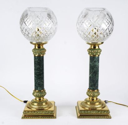 null Pair of lamps, large cut glass globes on sage-colored marble shaft mounted on...
