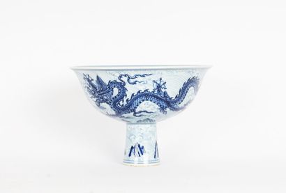 null CUP 

White cup on pedestal decorated with two blue dragons on patterned background,...