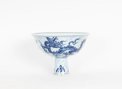 null CUP 

White cup on pedestal decorated with two blue dragons on patterned background,...