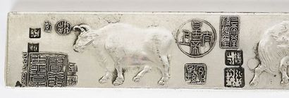 null PAPER WEIGHTS 

A pair of silver weights, decorated with buffaloes from the...