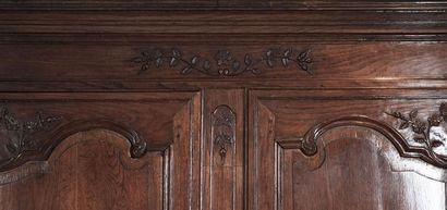 null 18th century cabinet in finely carved natural wood with two leaves, opens onto...