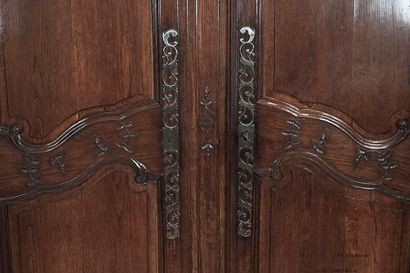 null 18th century cabinet in finely carved natural wood with two leaves, opens onto...