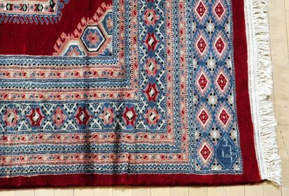 null Important Boukara rug with geometric patterns on a red background. Silky wool...
