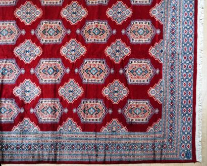 null Important Boukara rug with geometric patterns on a red background. Silky wool...