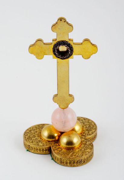 null Latin cross with brass trefoil ends. The cross is dotted with floral motifs...