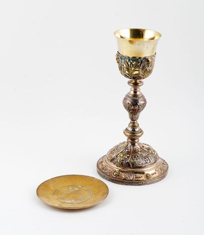 null Richly decorated silver metal chalice, with a more plain gilded metal paten.



The...