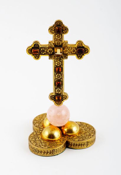 null Latin cross with brass trefoil ends. The cross is dotted with floral motifs...