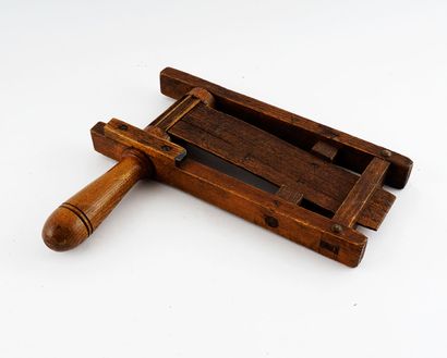 null Wooden rattle. A musical instrument in which wooden or metal blades are set...