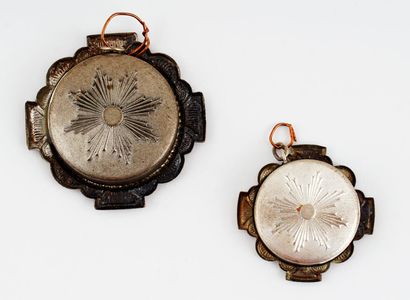 null A pair of reliquary pendants containing unknown pieces. The contents are sealed...