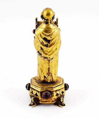 null Bronze reliquary representing a monk holding a church-shaped box. The box is...