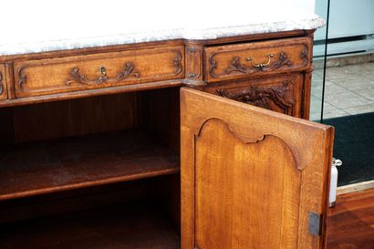 null Buffet in a row in the XIV style, in natural wood, richly carved with foliage...