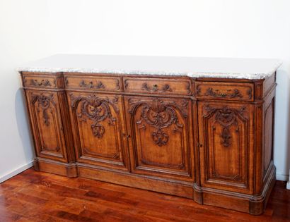 null Buffet in a row in the XIV style, in natural wood, richly carved with foliage...