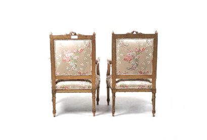 null Pair of Louis XVI style armchairs in gilded wood, with straight backs decorated...