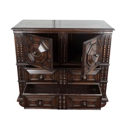 null English Jacobean style chest of drawers. The uprights are carved, as are the...