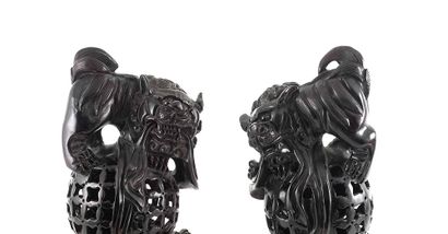 null CHINE / CHINA

A pair of openwork purple tan wood ornaments in shape on lions....