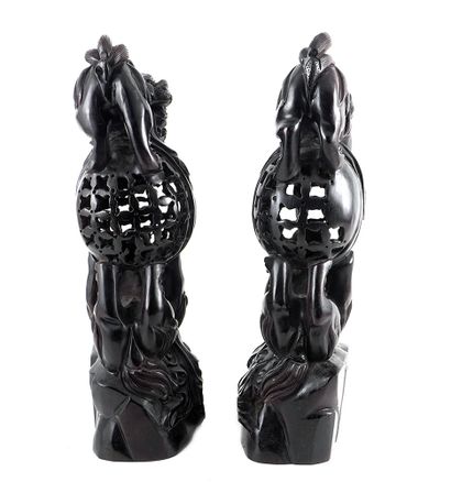 null CHINE / CHINA

A pair of openwork purple tan wood ornaments in shape on lions....