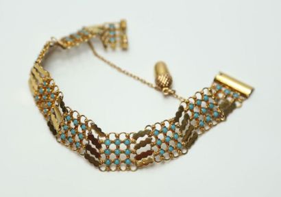 null Bracelet en or jaune 585 à motif stylisé et pierres bleues, avec chaînette à...