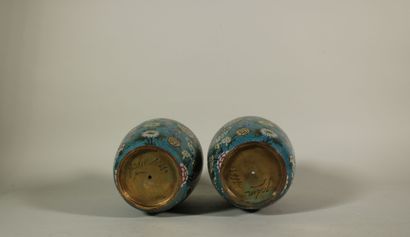 null A pair of cloisonné bronze baluster vases with floral decoration on a blue background....