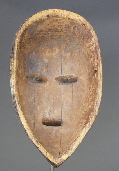null Hardwood mask with dark patina and white pigment highlights showing an oval...