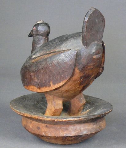 null Hardwood lid with a dark patina and a vigorous carving of a bird with swollen...