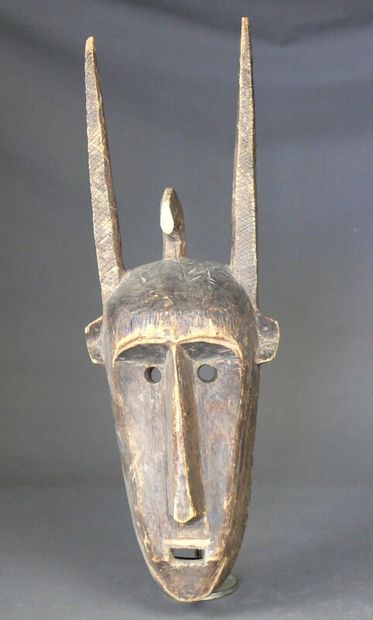 null N'tomo hardwood mask with natural patina and traces of pigment showing a stylized...