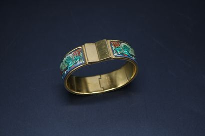 null Hermès, rigid opening bracelet, in gilded metal and printed enamel with a peacock...