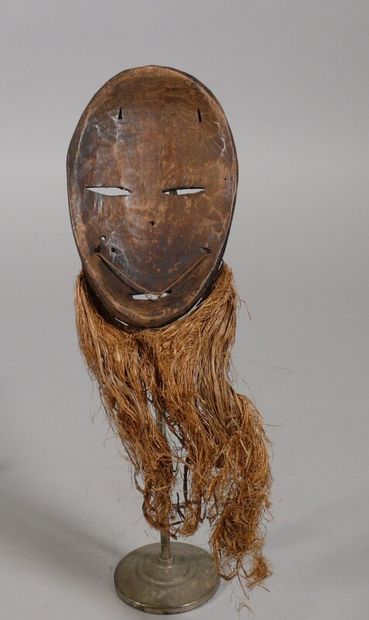 null Lukwakongo" mask in light wood with a dark patina and kaolin enhancement, showing...